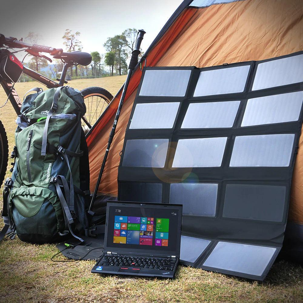 ALLPOWERS 100W Foldable Solar Panel SP012 set up at campsite with laptop and backpack, demonstrating outdoor charging capability